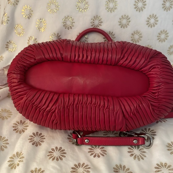 It’s called Burgundy, but looks like red. Rouched leather with silver hardware. - Picture 3 of 3